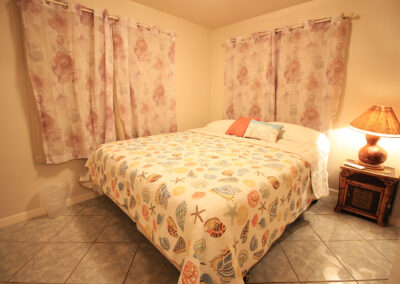 Bedroom #2 features a Cal-King bed and unique Hawaiian appointments. We love our "gourd" lamp.